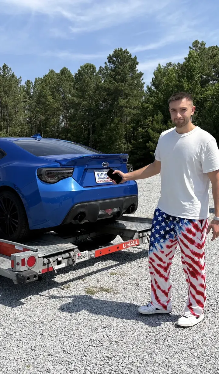Matt Madanat with his blue Subaru BRZ on a U-Haul car trailer after his first track attempt